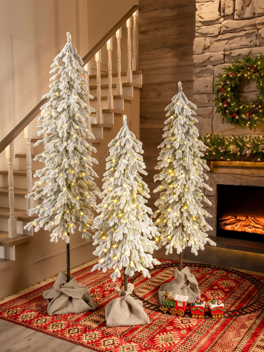 Christmas trees on wooden trunks artificial snow-covered molded with LED (set of 3)